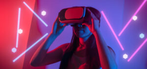 Young woman using glasses of virtual reality on dark background.